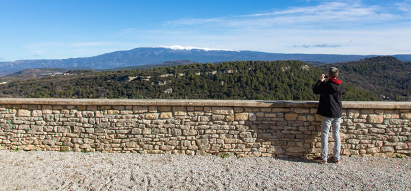 Man photographing mont ventoux covered in snow