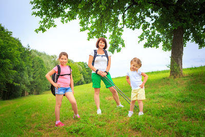 Full length of mother and daughter on grassy field