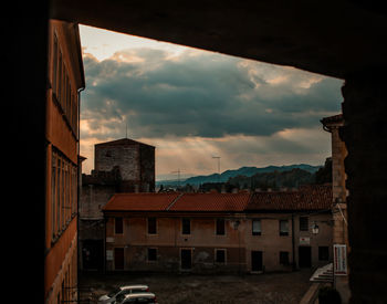 Buildings in city against sky at sunset