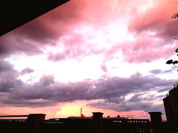 Low angle view of silhouette buildings against sky during sunset