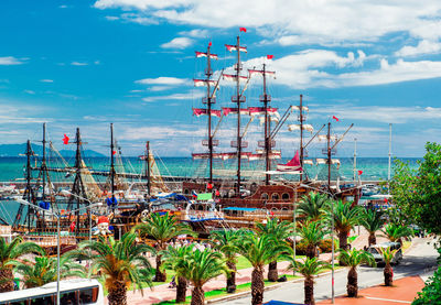 Sailboats in sea against sky