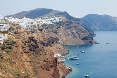 High angle view of sea and mountains against clear sky