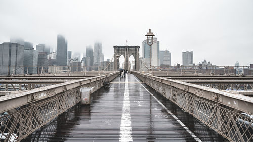 View of brooklyn bridge in city against sky