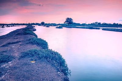 Scenic view of sea against sky at sunset