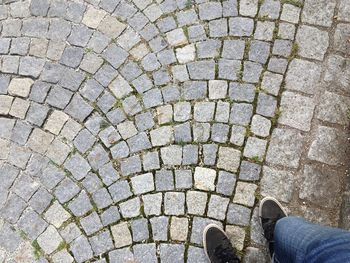 Low section of person standing on footpath