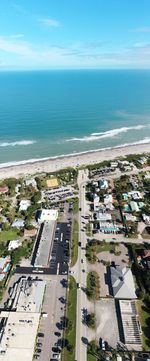 High angle view of buildings by sea against sky