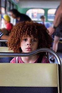 Portrait of cute boy sitting in bus