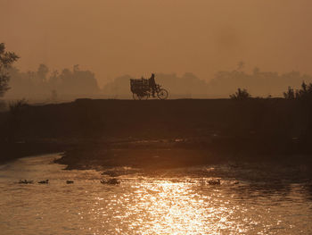 Scenic view of river against sky during sunrise 