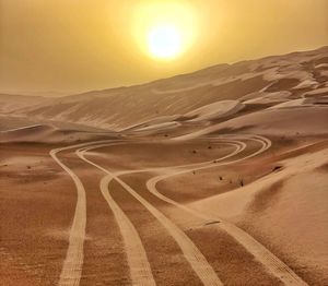 Scenic view of desert against sky during sunset