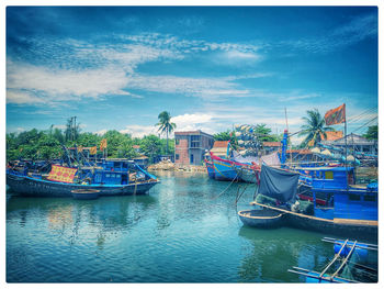 Boats moored in sea against sky