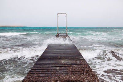 Pier over sea against sky