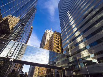 Low angle view of modern buildings in city against sky