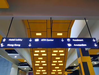 Low angle view of illuminated sign at night