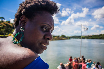 Close-up of woman looking away against sky