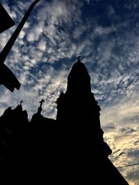 Low angle view of silhouette statue against sky