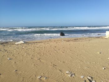 Scenic view of beach against clear sky