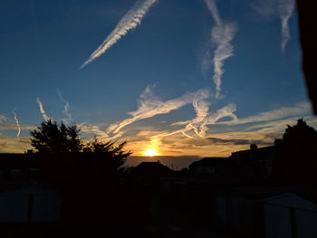 Low angle view of silhouette buildings against sky during sunset