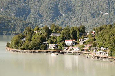 Scenic view of lake by trees and buildings