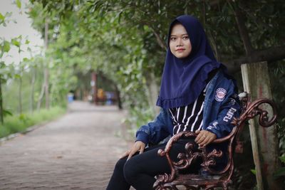 Portrait of young woman sitting outdoors