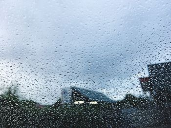 Raindrops on glass window in rainy season