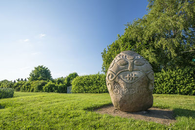 Stone wall on field against sky