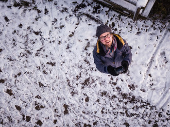 High angle view of man standing on snow field