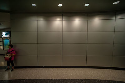 Rear view of woman walking in subway station