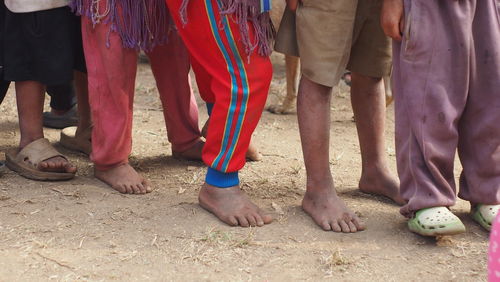 Low section of people standing on beach