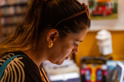 Side view of young woman using mobile phone