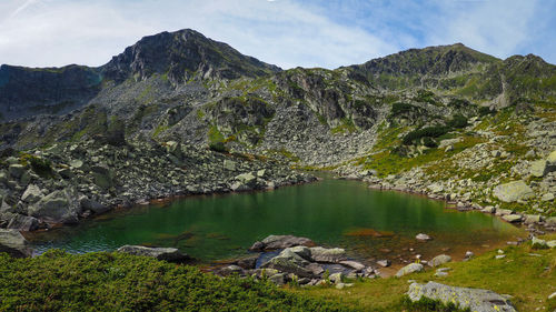 Scenic view of lake and mountains against sky