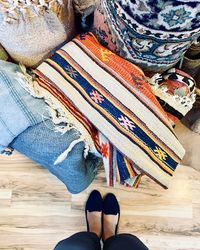 Low section of woman wearing multi colored shoes