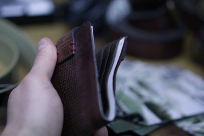 Close-up of hand holding wallet