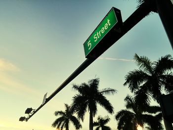 Low angle view of road sign against sky