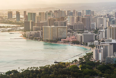 High angle view of buildings by sea against sky