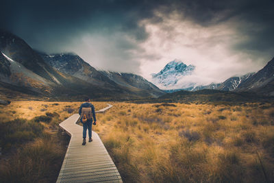 Full length of woman standing on mountain