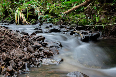 Stream flowing through rocks in sea