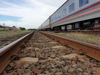 Train in railroad tracks against sky