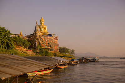 Temple building against sky during sunset