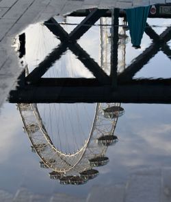 Low angle view of chain swing ride against sky