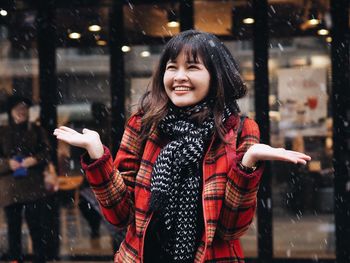 Smiling young woman enjoying during winter