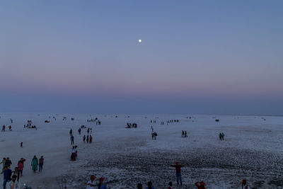 People on beach against sky