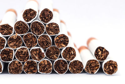 Close-up of cigarettes against white background