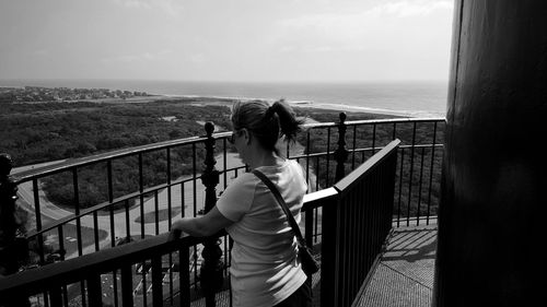 Rear view of woman looking at landscape against sky