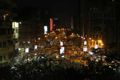 High angle view of illuminated street and buildings at night