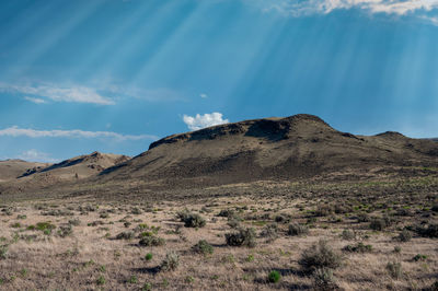 Scenic view of arid landscape against sky