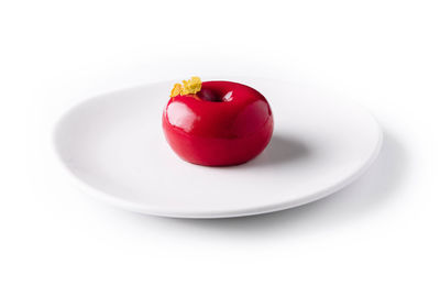 Close-up of tomatoes in plate on white background