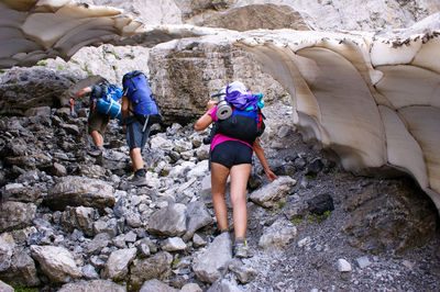 High angle view of people walking on rock