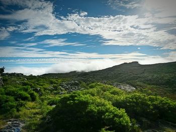 Scenic view of mountains against cloudy sky