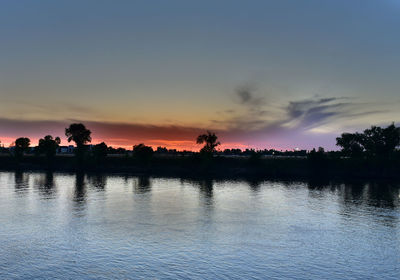 Scenic view of lake at sunset