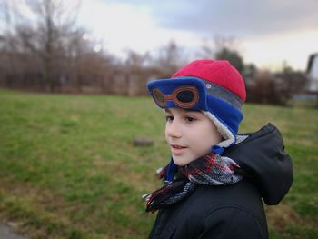 Portrait of boy wearing hat on field